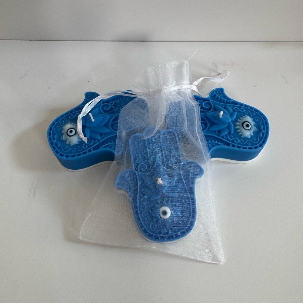 Hamsa candles make with soy and paraffin wax. Resin for base